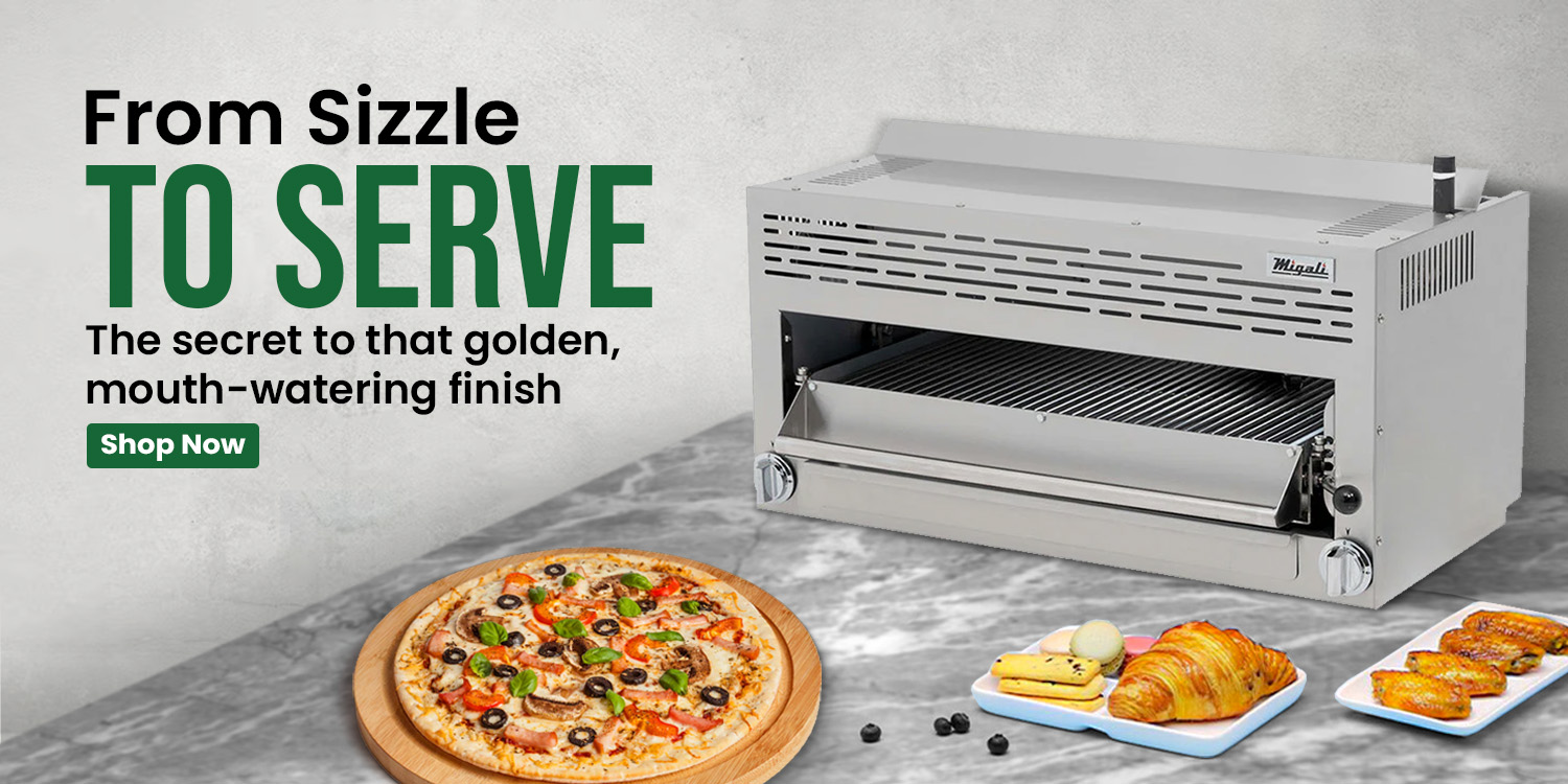 Stainless steel broiler with grilled food and baked goods on a countertop, promoting golden, mouth-watering finishes for commercial kitchens.